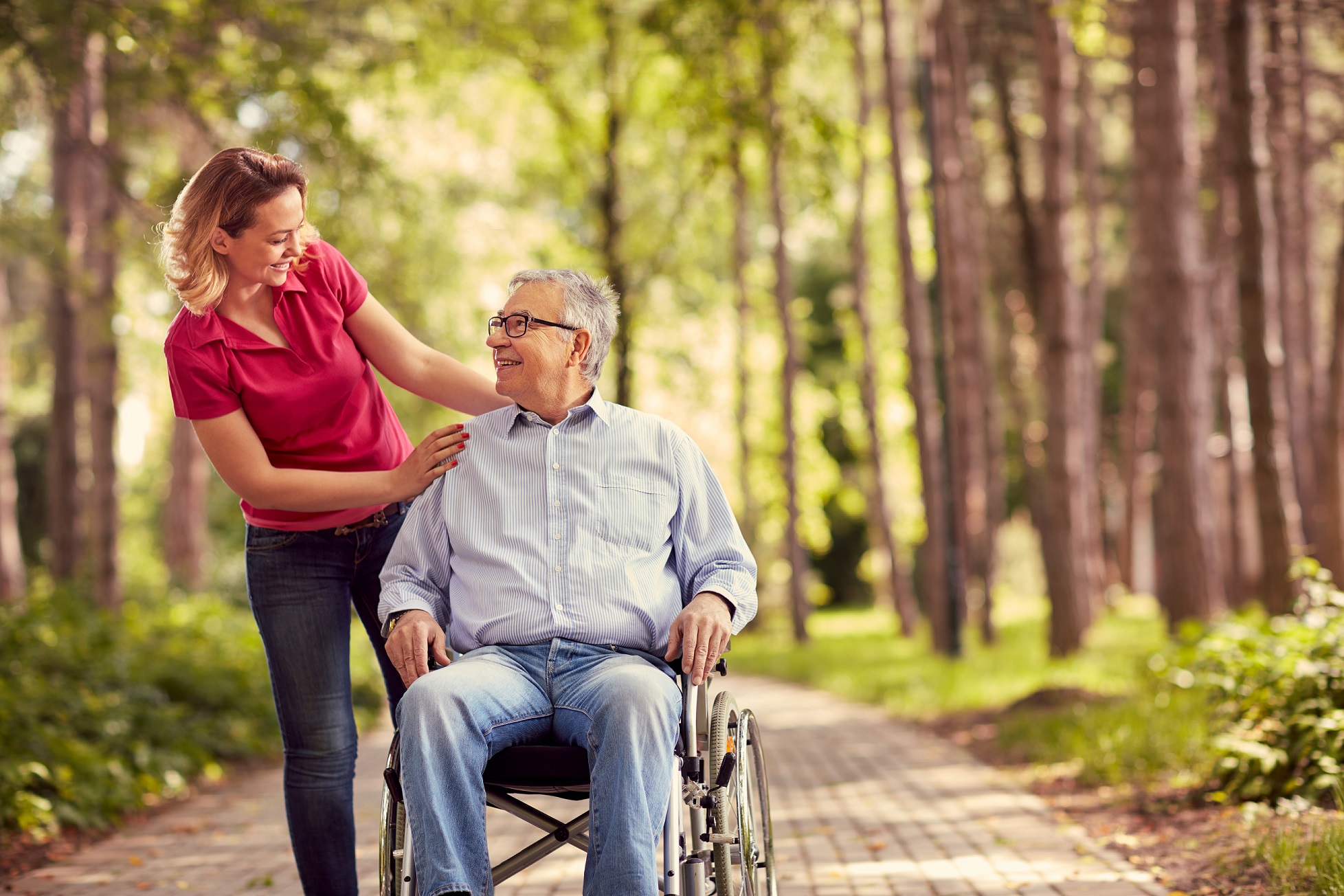 Smiling,Woman,With,Her,Disabled,Father,In,Wheelchair,Outdoor Woman taking walk with man in wheelchair