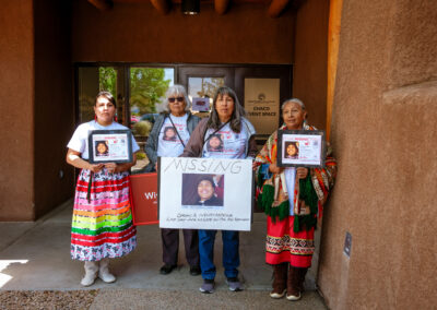 people holding missing posters at mmip day